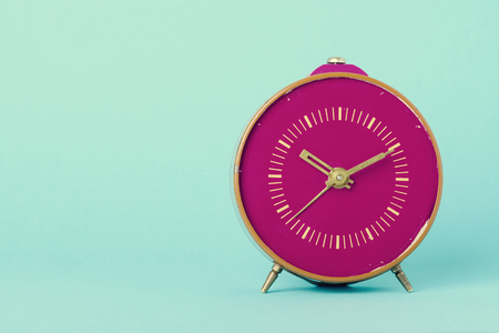 Retro clock on blue background with copy space, vintage tonedの写真素材