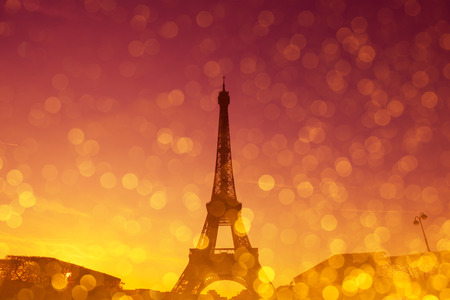 Eiffel Tower silhouette at evening sunset light in Paris France with shiny golden glitter double exposure effectの写真素材