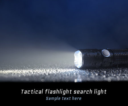 Tactical waterproof flashlight with place for textの写真素材