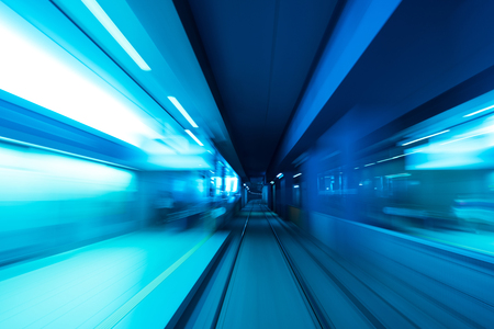 Underground subway tunnel blurred in speed motion and blue tonedの写真素材
