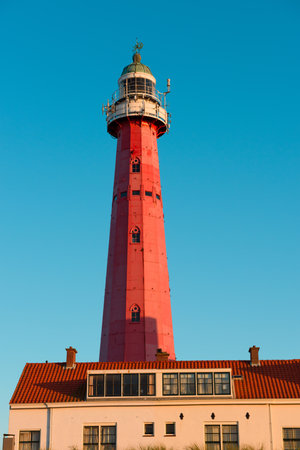 Scheveningen Lighthouse in Netherlands during sunset warm lightのeditorial素材