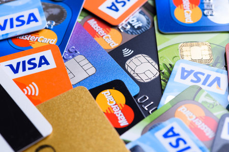 Krakow, Poland - June 16, 2017: Pile of plastic bank payment cards, Visa and Mastercard, credit and debit with different chips and wireless payment technology.のeditorial素材