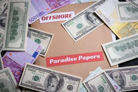 Folder with Paradise papers label on it with european and american currency, offshore tax heaven documents leak conceptの写真素材