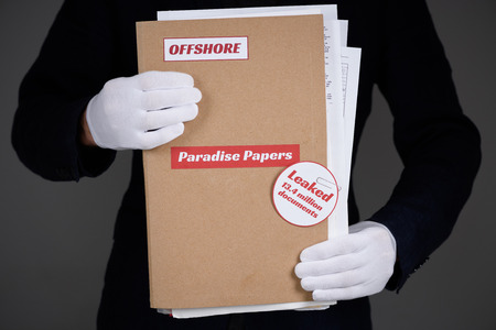 Folder with Paradise Papers and Offshore label with documents inside, tax heaven documents leak conceptの写真素材