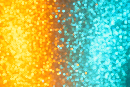 Colorful festive orange and cyan festive lights defocused bokeh abstract backgroundの写真素材