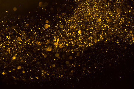 Flow wave of golden glitter dust shiny sparkle bokeh abstract backgroundの写真素材