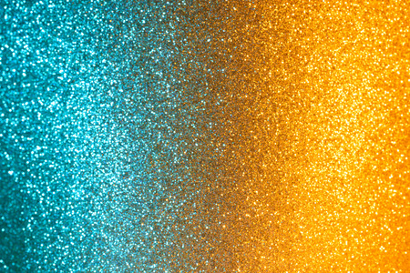 Dual colored cold and hot abstract defocused glitter lights bokehの写真素材