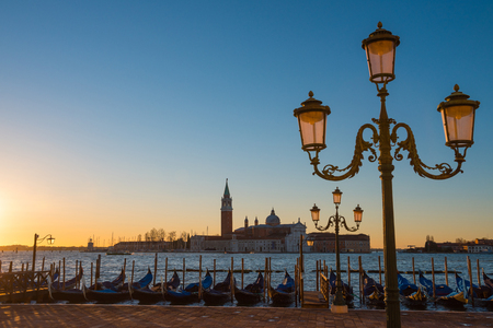 Venice Italy seafront with gondolas and lanterns at sunriseの写真素材