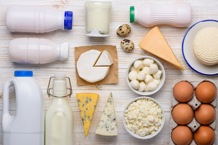 Dairy products assortment flat lay on white wooden tableの写真素材