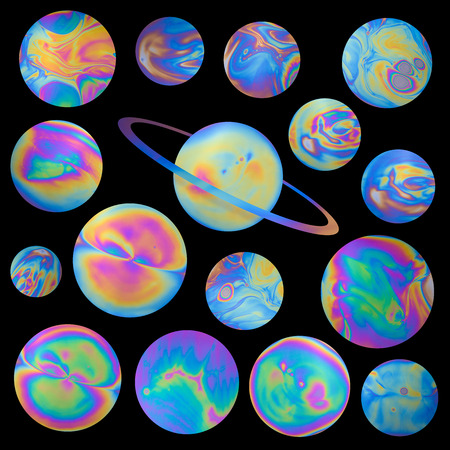 Colorful fantasy alien plantets with uniq vivid swirls and terrains isolated on black backgroundの写真素材