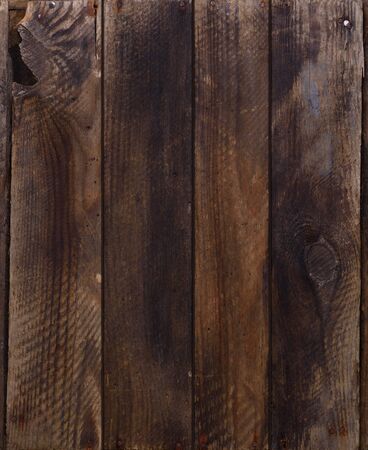 Dark weathered wooden planks with rusty nails backgroundの写真素材
