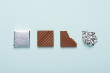 Chocolate bar life cycle on blue pastel paper background conceptの写真素材