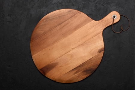 Pizza cutting board on dark rustic backgroundの写真素材