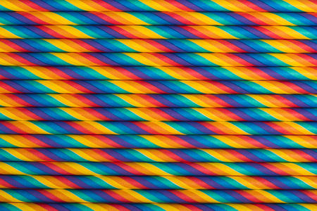 Rainbow vibrant multicolored striped paper straws backgroundの写真素材