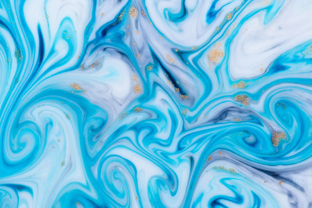 Marbled unique blue abstract background with gold dust. Flowing liquid marble texture.の写真素材