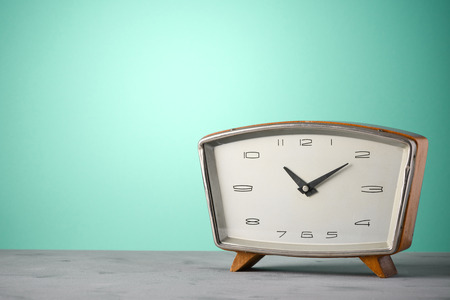 Retro classic wooden alarm clock vintage color background with copy spaceの写真素材