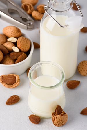 Organic almond milk with almonds and nutcrackerの写真素材