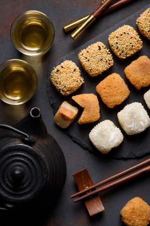 Mochi assortment with chopticks and tea traditional japanese rice dessert top viewの写真素材