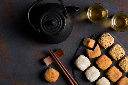 Mochi assortment with wooden chopticks and tea traditional japanese rice dessert flat lay top viewの写真素材