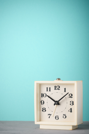 Retro alarm clock with blue background vertical copy spaceの写真素材
