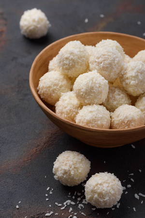 Coconut candies bowl on dark table backgroundの写真素材