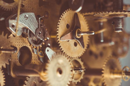 Vintage gears and cogs in mechanism macro retro tonedの写真素材
