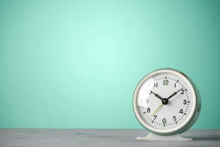 Retro old classic round alarm clock vintage color background with copy spaceの写真素材