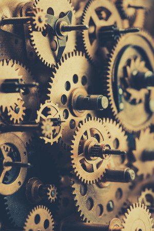 Vintage machine clock mechanism with gears and cogs macro vertical retro tonedの写真素材