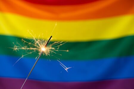 Sparkler and Gay pride LGBT flag. Pride month celebration party.の写真素材