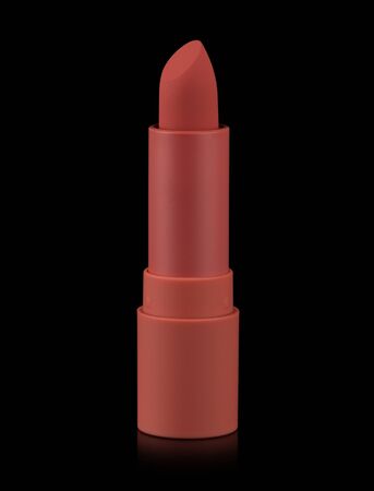 Red matte lipstick isolated on black background. Velvet satin airy lip stick new open.の写真素材