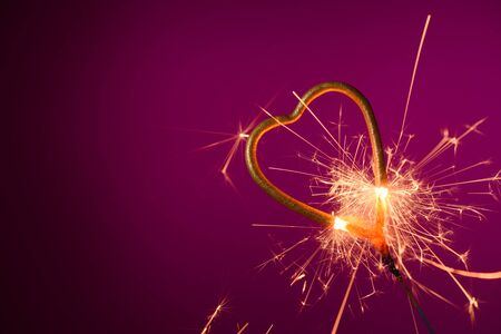 Sparkler love heart shape burning with many spakrsの写真素材
