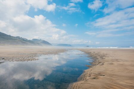 Empty sandy beach during ebbの写真素材