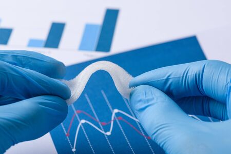 Scientist show layer of novel flexible foam like material in laboratoryの写真素材
