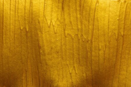 Metallic gold paint strokes texture backgroundの写真素材