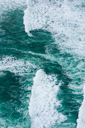 Emerald green ocean waves aerial drone top view