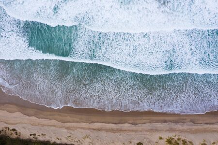 Ocean beach with blue waves aerial drone top viewの写真素材