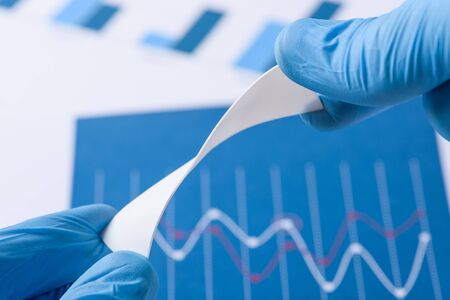 Novel flexible plastic material in scientist hands in laboratory conceptの写真素材
