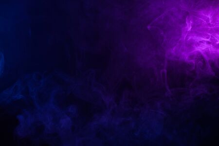 Soft clouds of colorful smoke on dark backgroundの写真素材