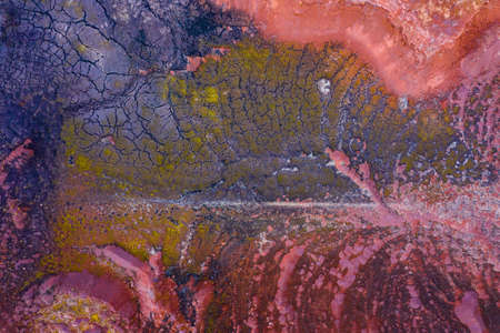 Aerial drone view of industrial chemicals dump site, dry multicolored soil, unique texture.の写真素材