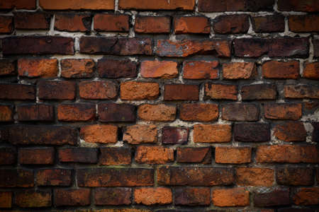 Brick wall red old weathered texture background. Grunge old house aged dark bricks.の写真素材
