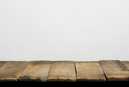 Empty wooden table top from rustic old wood planks, neutral gray background.の写真素材