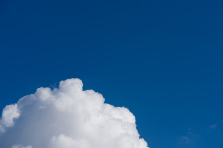Fluffy white cloud on deep blue skyの写真素材