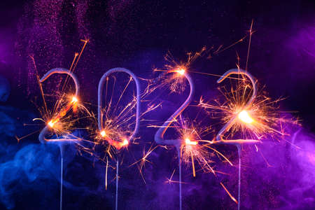 2022 Happy new year card with with sparklers shiny glitter and colorful smokeの写真素材
