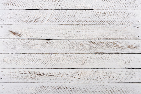 Old white grunge painted and sanded wood backgroundの写真素材