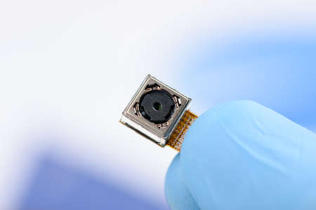 Cell phone camera module in scientist handの写真素材
