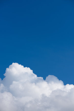 Fluffy white cloud on deep blue skyの写真素材