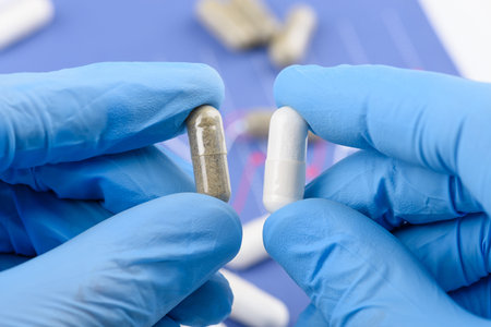 Scientist compare two transparent capsules with different drug content.