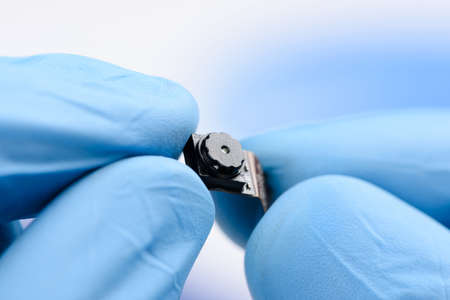 Smartphone camera module in scientist hands. New sensor with high resolution technology concept.の写真素材