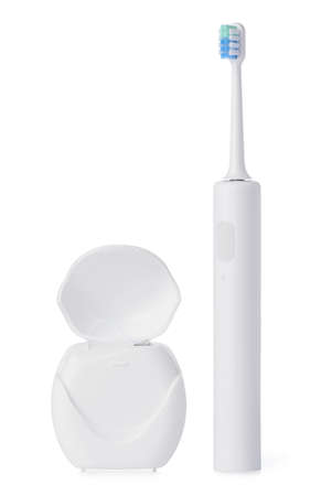 Dental floss and electric toothbrush set isolated on white backgroundの写真素材