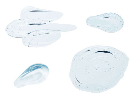 Clear liquid serum gel smudges with bubbles set isolated on white backgroundの写真素材